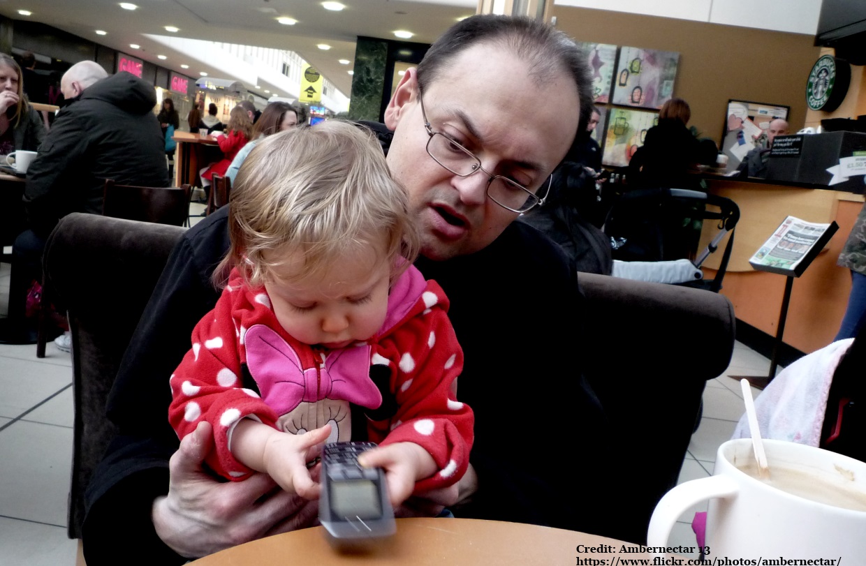 Father and child with phone: photo by Ambernectar 13 Flickr https://www.flickr.com/photos/ambernectar/